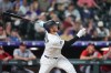 Colorado Rockies' Hunter Goodman follows the flight of his solo home run off Washington Nationals relief pitcher Clayton Beeter in the eighth inning of a baseball game Tuesday, July 21, 2026, in Denver. (AP Photo/David Zalubowski)