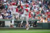 Cincinnati Reds' Eugenio Suárez, right, celebrates his solo home run with third base coach Willie Harris, left, as he runs the bases during the fourth inning of a baseball game against the Seattle Mariners, Tuesday, July 21, 2026, in Seattle. (AP Photo/Lindsey Wasson)