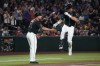 Arizona Diamondbacks' Max Kepler, right, celebrates with third base coach J.R. House (71) after hitting a three-run home run against the Athletics in the first inning of a baseball game, Tuesday, July 21, 2026, in Phoenix. (AP Photo/Rick Scuteri)