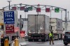 Trucks stop near the Peace Bridge U.S.-Canada border crossing, Friday, March 20, 2026, in Buffalo, N.Y. (AP Photo/Yuki Iwamura)