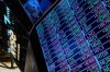 A board above the trading floor of the New York Stock Exchange with stock symbols is shown in this image, Tuesday, July 1, 2025. (AP Photo/Richard Drew)