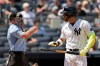 New York Yankees' José Caballero reacts after striking out in front of home plate umpire Quinn Wolcott (81) in the sixth inning during the first baseball game of a doubleheader against the Pittsburgh Pirates, Wednesday, July 22, 2026, in New York. (AP Photo/Adam Hunger)