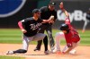 Cleveland Guardians' Chase DeLaute (24) steaos second base on Minnesota Twins shortstop Ryan Kreidler, left, in the fourth inning of a baseball game in Cleveland, Thursday, July 23, 2026. (AP Photo/Sue Ogrocki)