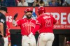 Texas Rangers' Jake Burger (21) is celebrates hitting a home run with Texas Rangers' Ezequiel Duran during the fourth inning of a baseball game against the Seattle Mariners, Friday, July 24, 2026, Arlington, Texas. (AP Photo/Jessica Tobias)