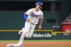 Texas Rangers' Wyatt Langford runs over third base on his way to scoring on a triple by teammate Ezequiel Duran during the first inning of a baseball game against the Seattle Mariners, Saturday, July 25, 2026, in Arlington, Texas. (AP Photo/LM Otero)
