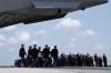 President Donald Trump and Secretary of Defense Pete Hegseth and others, salute as a U.S. Army carry team moves a transfer case containing the remains of Sgt. Angel S. Rampersad, of Ozone Park, N.Y. Wednesday, July 22, 2026, at Dover Air Force Base, Del. (AP Photo/Matt Rourke)
