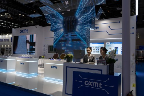 FILE - Workers at the booth for Chinese DRAM producer ChangXin Memory Technologies, also known as CXMT, wait for visitors at the 21st China International Semiconductor Expo in Beijing, Nov. 20, 2024. (AP Photo/Ng Han Guan, File)