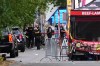 A crime scene photographer arrives as law enforcement examines the scene following a shooting at Seattle Center during the Bite of Seattle food festival Sunday, July 26, 2026, in Seattle. (AP Photo/Lindsey Wasson)