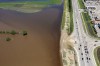 A dike along 18th Street holds back the swollen Assiniboine River in Brandon, Man. as seen from the air on Sunday, July 6, 2014. THE CANADIAN PRESS/Tim Smith