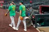 Athletics' Tommy White, left, and Alika Williams wear a Lasko No. 22 t-shirt in honor of injured Athletics minor league player Ryan Lasko prior to a baseball game against the Arizona Diamondbacks, Wednesday, July 22, 2026, in Phoenix. (AP Photo/Ross D. Franklin)
