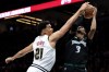 FILE - Minnesota Timberwolves forward Jaden McDaniels, right, shoots as Denver Nuggets forward Spencer Jones (21) defends during the second half of Game 6 of a first-round NBA basketball playoffs series, April 30, 2026, in Minneapolis. (AP Photo/Matt Krohn, File)