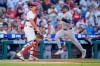 New York Yankees' Austin Wells, right, comes in to score on the single by Cody Bellinger as Philadelphia Phillies catcher J.T. Realmuto, left, looks on during the sixth inning of a baseball game, Saturday, July 25, 2026, in Philadelphia. (AP Photo/Chris Szagola)