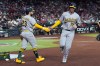 Athletics' Jonah Heim (15) celebrates his run scored against the Arizona Diamondbacks with Athletics' Shea Langeliers (23) during the third inning of a baseball game, Wednesday, July 22, 2026, in Phoenix. (AP Photo/Ross D. Franklin)