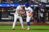 New York Mets third base coach Tim Leiper, left, celebrates with Francisco Lindor as he runs the bases after hitting a three-run home run during the eighth inning of a baseball game against the Atlanta Braves Monday, July 27, 2026, in New York. (AP Photo/Frank Franklin II)
