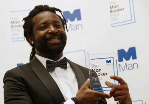 FILE - Marlon James poses with the award after his book 'A Brief History of Seven Killings' was named as winner of the 2015 Booker Prize 2015 for Fiction, following the award ceremony at the Guildhall in London, Tuesday, Oct. 13, 2015.(AP Photo/Alastair Grant, file)