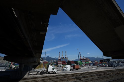 A transport truck carries a cargo container at the Port of Vancouver, on Friday, July 14, 2023. THE CANADIAN PRESS/Darryl Dyck