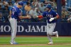 Texas Rangers' Austin Wynns celebrates his solo home run off Tampa Bay Rays pitcher Steven Matz with third base coach Corey Ragsdale (64) during the seventh inning of a baseball game Tuesday, July 28, 2026, in St. Petersburg, Fla. (AP Photo/Chris O'Meara)