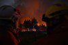 Firefighters battle a blaze outside Lanton, during wildfires in southwestern France, Tuesday, July 28, 2026. (AP Photo/Emma Da Silva)