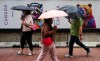 People make their way through the rain in downtown Ottawa on Monday, June 9, 2025. THE CANADIAN PRESS/Sean Kilpatrick