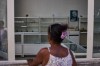 An image of Fidel Castro hangs on the wall of a state-run pharmacy where a woman asks for medication in Havana, Cuba, Wednesday, July 29, 2026. (AP Photo/Ramon Espinosa)