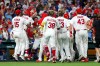St. Louis Cardinals' Iván Herrera is mobbed by teammates as they celebrate his walk-off double during the tenth inning of a baseball game against the Chicago Cubs, Wednesday, July 29, 2026, in St. Louis. (AP Photo/Scott Kane)