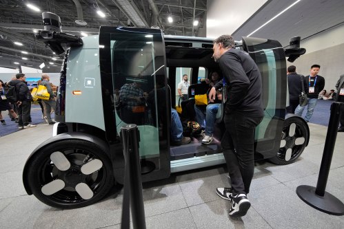 FILE - People view a Zoox self-driving vehicle at the company's booth during the CES tech show, Jan. 7, 2025, in Las Vegas. (AP Photo/John Locher, File)