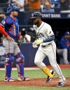 Texas Rangers catcher Austin Wynns looks away as Tampa Bay Rays' Cedric Mullins crosses home plate after hitting a home run during the eighth inning of a baseball game Thursday, July 30, 2026, in St. Petersburg, Fla. (AP Photo/Jason Behnken)