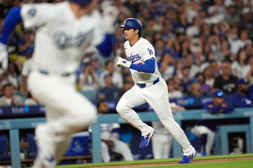 Los Angeles Dodgers' Shohei Ohtani (17) scores on an infield hit by Freddie Freeman (5) against the Seattle Mariners during the third inning of a baseball game Wednesday, July 29, 2026, in Los Angeles. (AP Photo/Scott Strazzante)