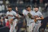 San Francisco Giants first baseman Rafael Devers, center, celebrates with teammates second baseman Luis Arraez, left, and third baseman Christian Koss after the Giants defeated the San Diego Padres 4-1 in a baseball game Thursday, July 30, 2026, in San Diego. (AP Photo/Gregory Bull)