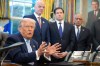 FILE - President Donald Trump answers questions from reporters during a meeting with the White House task force on the 2026 FIFA World Cup in the Oval Office of the White House, Monday, Nov. 17, 2025, in Washington, as FIFA President Gianni Infantino, Secretary of State Marco Rubio and FIFA senior adviser Carlos Cordeiro listen. (AP Photo/Evan Vucci, file)