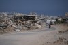 A Palestinian man rides his bicycle by the rubble of buildings that were destroyed during the Israel Hamas war, in Khan Younis, southern Gaza Strip, Friday, July 31, 2026. (AP Photo/Abdel Kareem Hana)