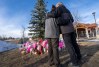 A couple embrace in front of a memorial to honour the victims of a mass shooting in Tumbler Ridge, B.C., on Thursday, Feb. 12, 2026. THE CANADIAN PRESS/Christinne Muschi