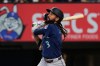 Seattle Mariners' J.P. Crawford follows through on a sacrifice fly that scored Josh Naylor in the ninth inning of a baseball game against the Texas Rangers in Arlington, Texas, Monday, July 27, 2026. (AP Photo/Tony Gutierrez)