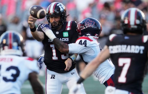 Montreal Alouettes' Kylan Guidry (44) hits Ottawa Redblacks quarterback Jake Maier (13) as he attempts a pass during first half CFL action in Ottawa, Friday, July 31, 2026. THE CANADIAN PRESS/Adrian Wyld
