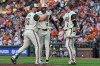 Baltimore Orioles' Pete Alonso (25) celebrates with Dylan Beavers (12) and Gunnar Henderson (2) after hitting a two-run home run during the first inning of a baseball game against the Philadelphia Phillies, Friday, July 31, 2026, in Baltimore. (AP Photo/Stephanie Scarbrough)