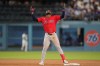 Boston Red Sox's Andruw Monasterio gestures after hitting a two RBI double during the seventh inning of a baseball game against the Los Angeles Dodgers, Friday, July 31, 2026, in Los Angeles. (AP Photo/Mark J. Terrill)