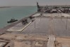 This aerial photo shows the port of Umm Qasr empty of commercial ships and cargo ships, near the city of Basra, 340 miles (550 kilometers) southeast of Baghdad, Iraq, Tuesday, July 28, 2026. (AP Photo/Ali Rahim)
