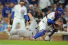 New York Yankees' Spencer Jones slides into home plate on New York Yankees' José Caballero's RBI single during the fifth inning of a baseball game against the Chicago Cubs, Saturday, Aug. 1, 2026, in Chicago. (AP Photo/Melissa Tamez)