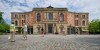 FILE - Visitors walk the grounds of the festival opera house 
