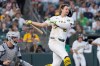 Athletics' Nick Kurtz loses his batting helmet on a swing during the fifth inning of a baseball game against the Detroit Tigers, Friday, July 31, 2026, in West Sacramento, Calif. (AP Photo/Sara Nevis)