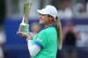 Shiho Kuwaki, of Japan celebrates with the trophy after winning the Women's British Open golf championship in Lytham St Annes, England, Sunday, Aug. 2, 2026. (AP Photo/Jon Super)