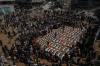 Bodies of members of the Hassayna and Abu Sharia families, killed in an Israeli strike in 2023 and recently recovered from the rubble, are draped in Palestinian flags during their funeral in Gaza City, Tuesday, Aug. 4, 2026. (AP Photo/Jehad Alshrafi)