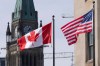 Canadian and United States flags fly near Parliament Hill, Wednesday, March 22, 2023 in Ottawa. THE CANADIAN PRESS/Adrian Wyld
