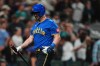 Seattle Mariners' Mitch Garver walks back to the dugout after striking out during the ninth inning to end a baseball game in a loss to the Minnesota Twins, Friday, July 31, 2026, in Seattle. (AP Photo/Lindsey Wasson)