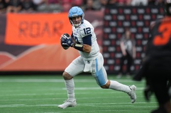 Toronto Argonauts quarterback Chad Kelly runs with the ball as he looks for a receiver during the first half of a CFL football game against the B.C. Lions in Vancouver, on Saturday, July 25, 2025. THE CANADIAN PRESS/Darryl Dyck