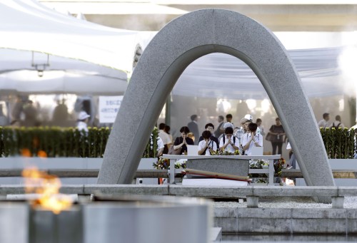 Visitors pray in front of the cenotaph dedicated to the victims of the atomic bombing ahead of a ceremony to mark the anniversary of the bombing at the Hiroshima Peace Memorial Park in Hiroshima, western Japan Thursday, Aug. 6, 2026. (Mizuki Sakai/Kyodo News via AP)