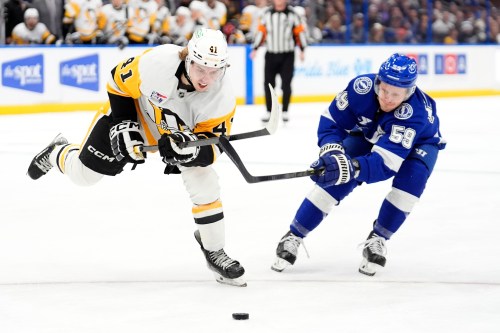 FILE - Pittsburgh Penguins right wing Ville Koivunen (41) beats Tampa Bay Lightning center Jake Guentzel (59) to the puck during the first period of an NHL hockey game, Dec. 4, 2025, in Tampa, Fla. (AP Photo/Chris O'Meara, File)