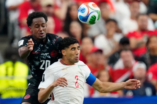 Canada's Ali Ahmed (20) and Morocco's Achraf Hakimi (2) vie for control of the ball during first half FIFA World Cup round of 16 soccer action, in Houston, Saturday, July 4, 2026. THE CANADIAN PRESS/Frank Gunn
