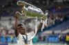 FILE - Real Madrid's Vinicius Junior holds up the trophy after winning the Champions League final soccer match between Liverpool and Real Madrid in Saint Denis near Paris, May 29, 2022. (AP Photo/Kirsty Wigglesworth, File)