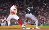 Boston Red Sox's Caleb Durbin, left, beats the throw to Chicago White Sox's Munetaka Murakami (5) on a single during the fourth inning of a baseball game, Thursday, Aug. 6, 2026, in Boston. (AP Photo/Charles Krupa)